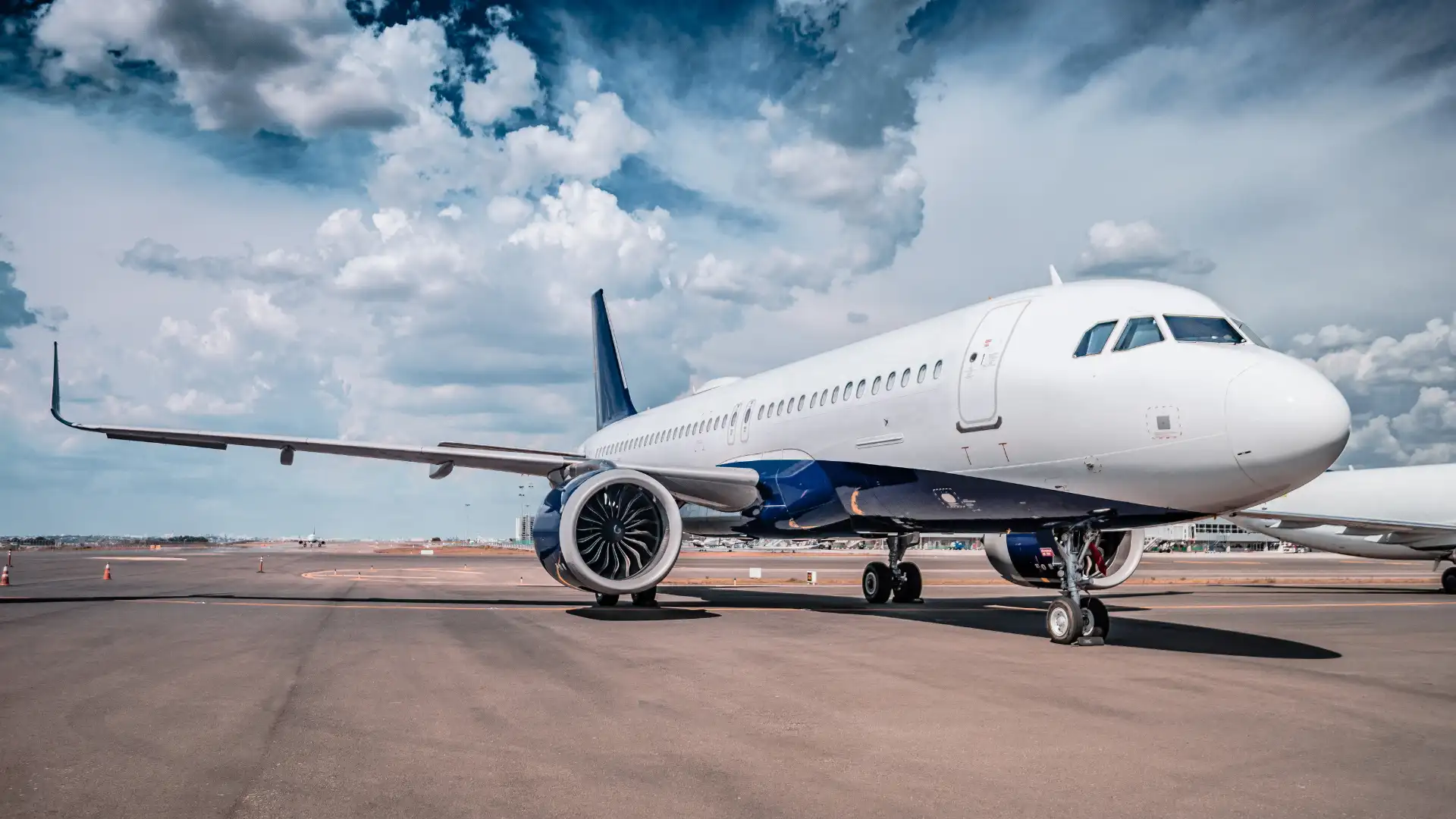 Commercial airplane parked on an airport runway.